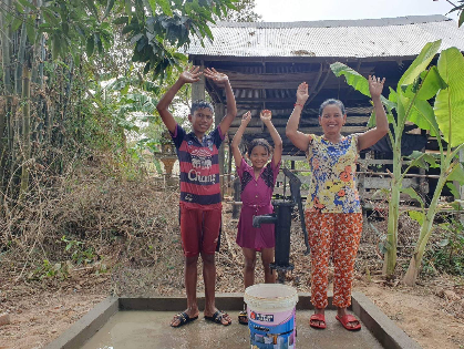 井戸の前の家族